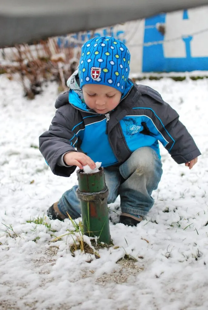 A young child exploring in the snow